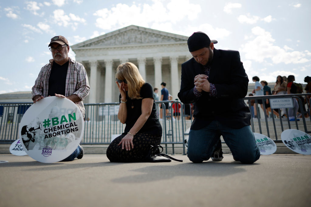 Mark Lee Dickson (far right), director of Right to Life East Texas, prays in front of the U.S. Supreme Court on April 21, 2023 in Washington, DC. (Chip Somodevilla/Getty Images)