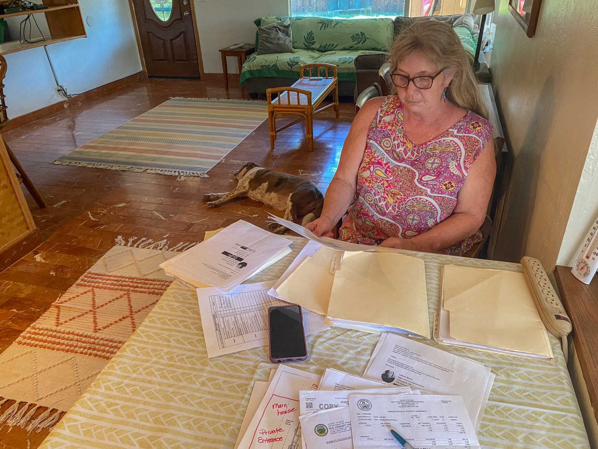 Bettina Robinson went through the documents, emails and receipts she accumulated during the process to have her home in Kihei part of the Federal Emergency Management Agency’s direct-lease program. (Cammy Clark/Civil Beat/2024)