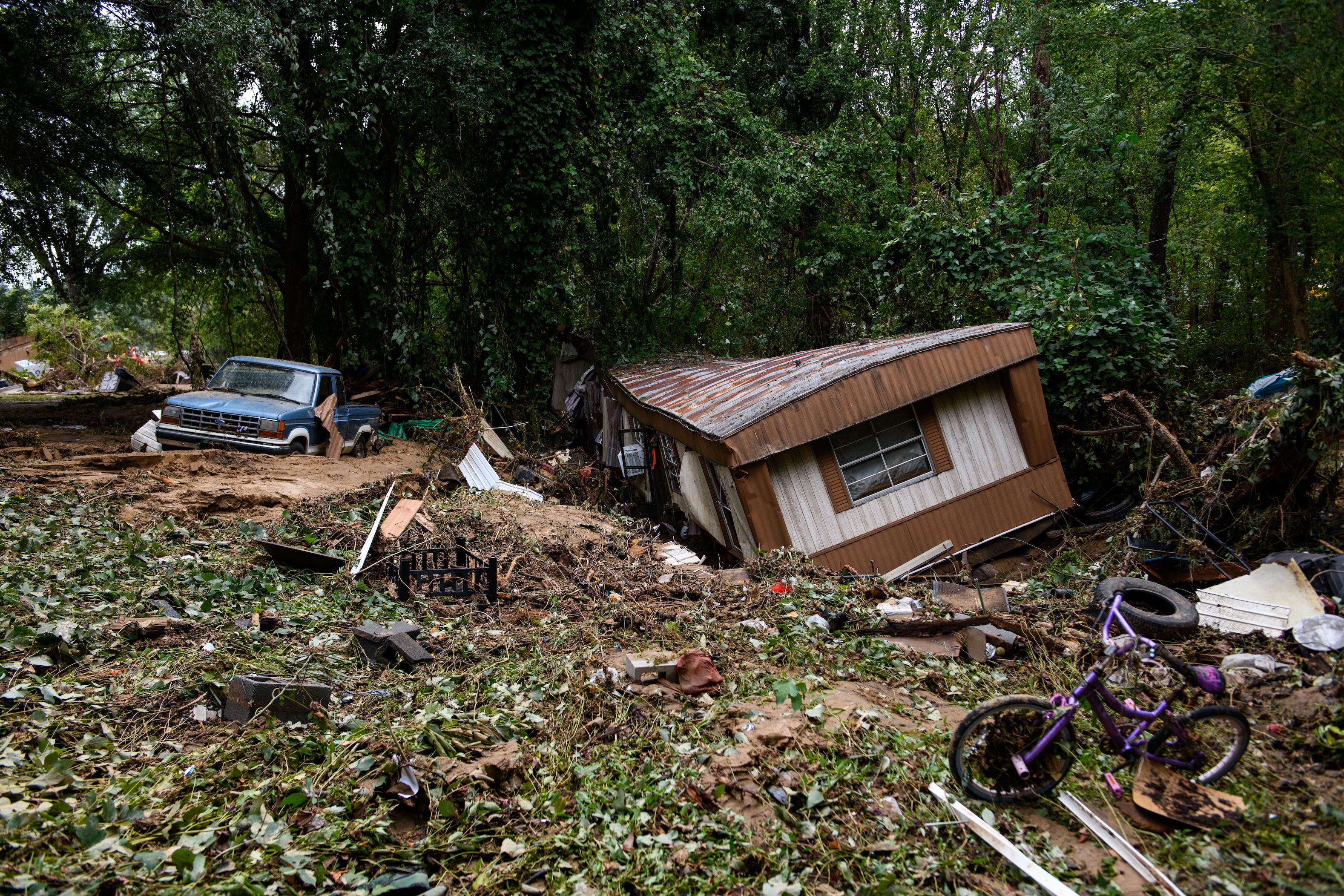 Debris and a mobile home are piled up along a tree line in the aftermath of Hurricane Helene on Sept. 29, 2024 in Old Fort, North Carolina. (Photo by Melissa Sue Gerrits/Getty Images)