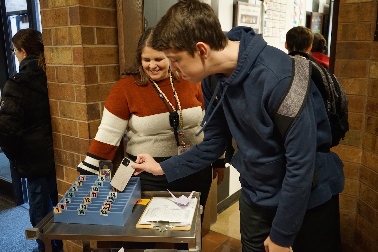 Riverton High School culinary arts teacher Kelli Gard wheels out a cellphone caddy when she greets students at the door so they can deposit their phones before they enter class. (Katie Klingsporn/WyoFile)