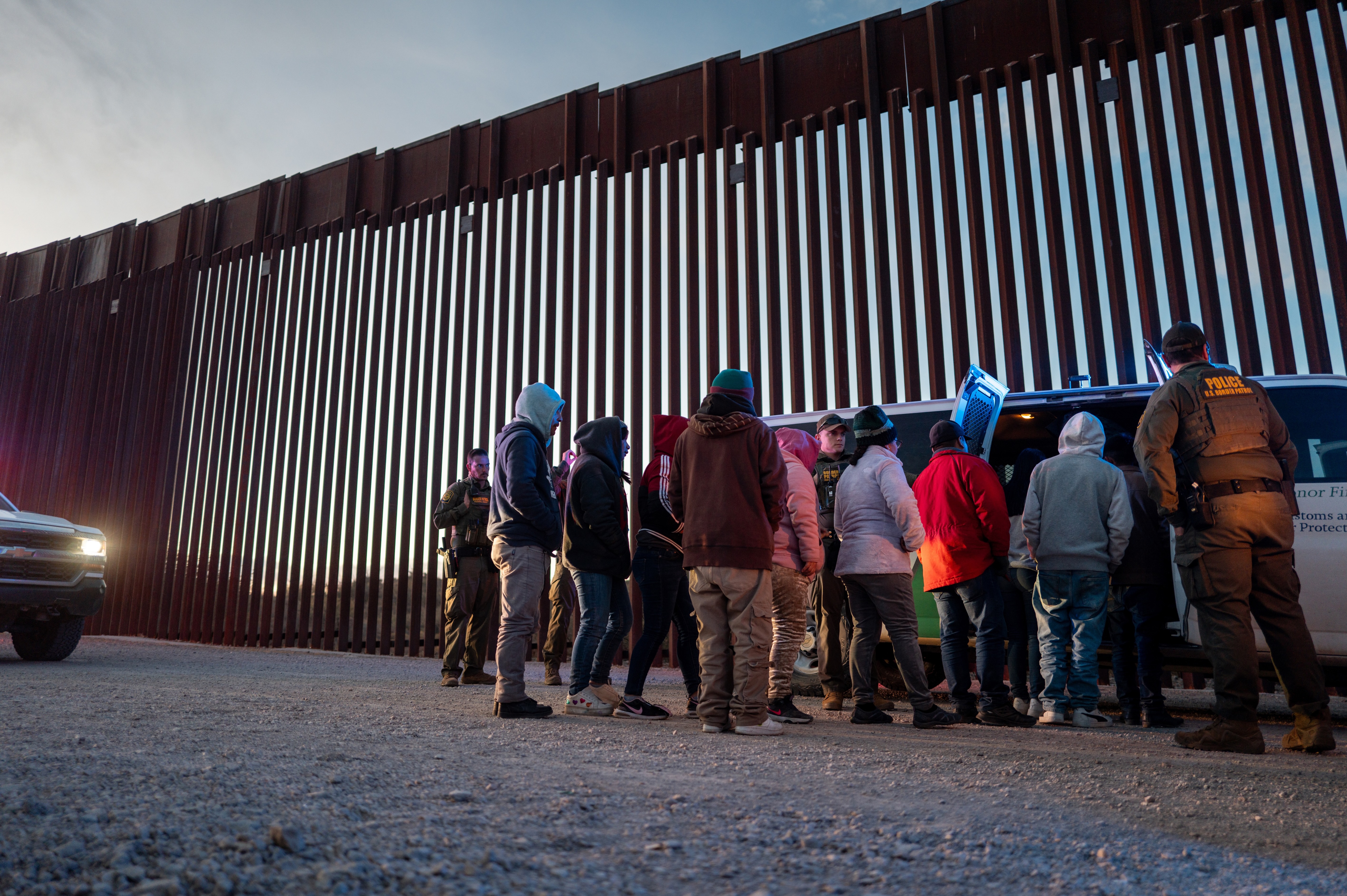 Migrants from Mexico and Guatemala are apprehended by U.S. Customs and Border Patrol officers after crossing a section of border wall into the United States on Jan. 4, 2025, in Ruby, Arizona. (Photo by Brandon Bell/Getty Images)
