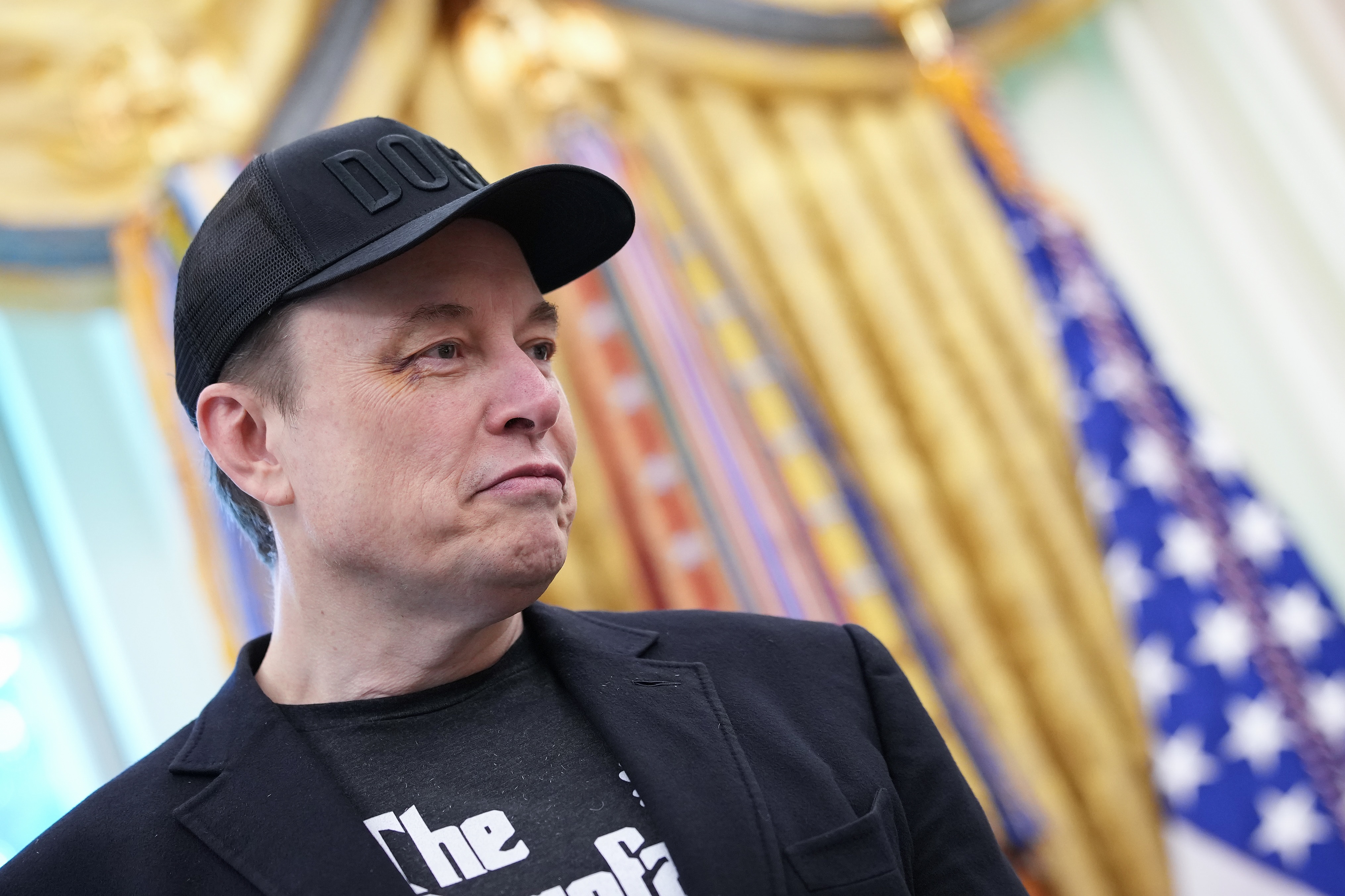 Tesla CEO Elon Musk listens as President Donald Trump speaks to reporters in the Oval Office of the White House on May 30, 2025 in Washington, D.C. (Photo by Kevin Dietsch/Getty Images)