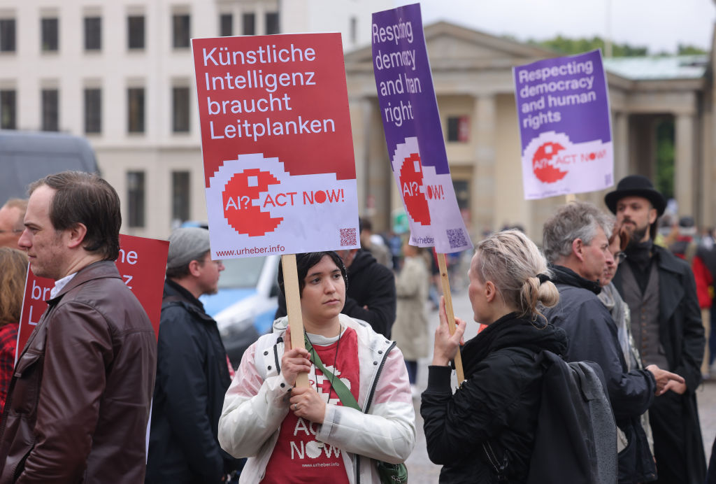 Members of the group Initiative Urheberrecht (authors' rights initiative) demonstrate to demand regulation of artificial intelligence on June 16, 2023 in Berlin, Germany. The AI regulation later adopted by the European Union is a model for many U.S. lawmakers interested in consumer protection but a cautionary tale for others who say they're interested in robust innovation, experts say.(Photo by Sean Gallup/Getty Images)