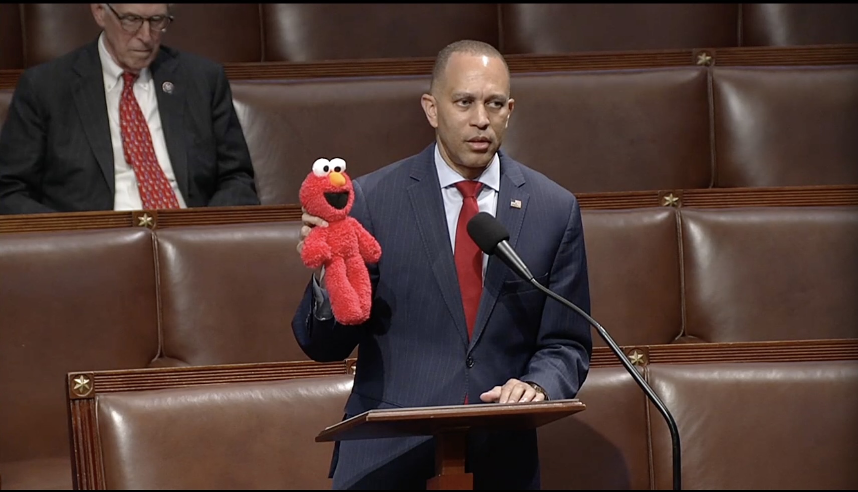 U.S. House Minority Leader Hakeem Jeffries, D-N.Y., holds up an Elmo toy while the chamber debates a bill that would eliminate previously approved funding for the Corporation for Public Broadcasting, which provides grants to public radio and television stations, including the Public Broadcasting Service, or PBS, which airs "Sesame Street." (Screen shot taken from House Clerk website livestream).