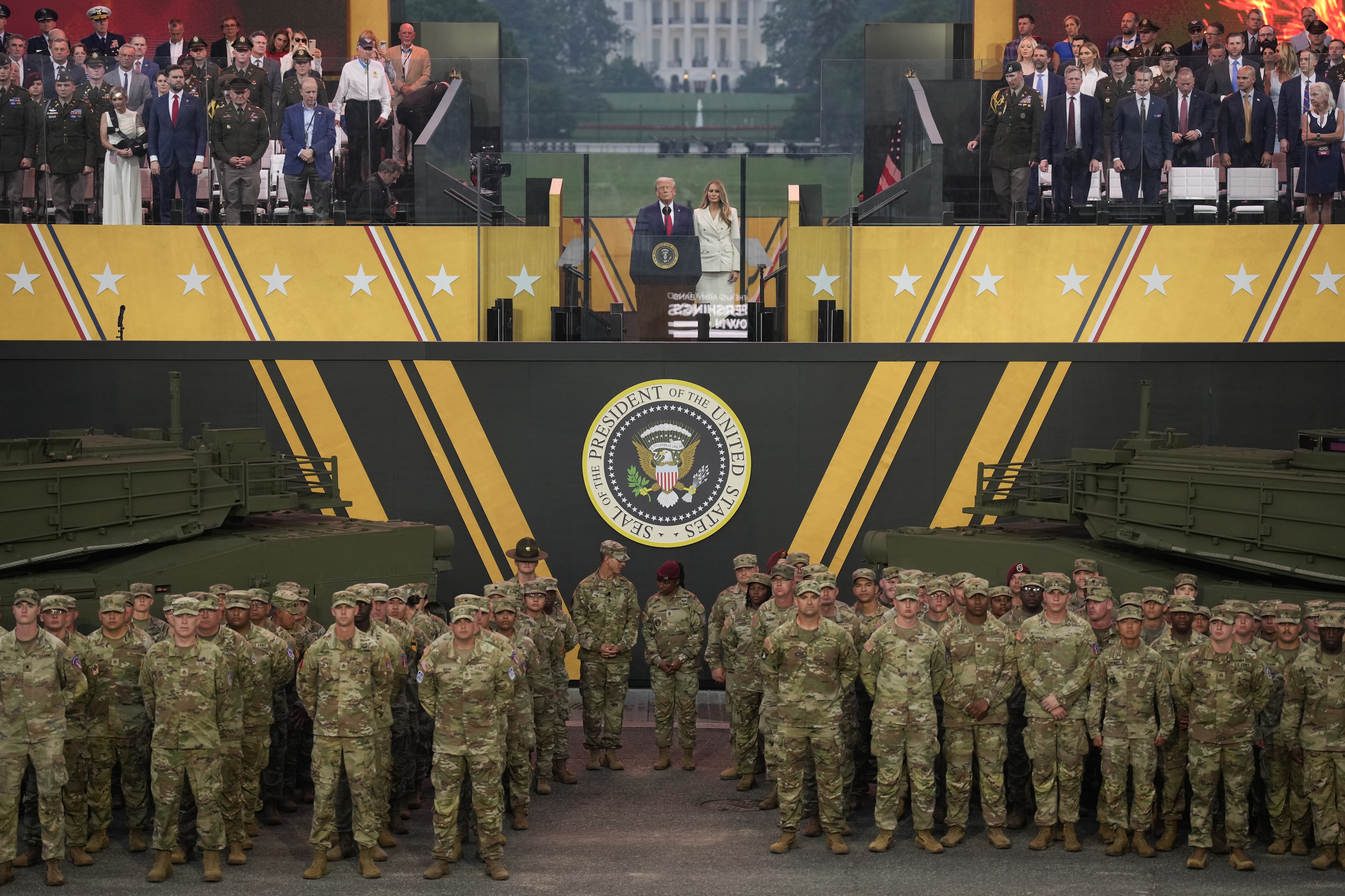 U.S. President Donald Trump and First Lady Melania Trump stand together at the end of the U.S Army parade on June 14, 2025 in Washington, D.C. (Photo by Andrew Harnik/Getty Images)
