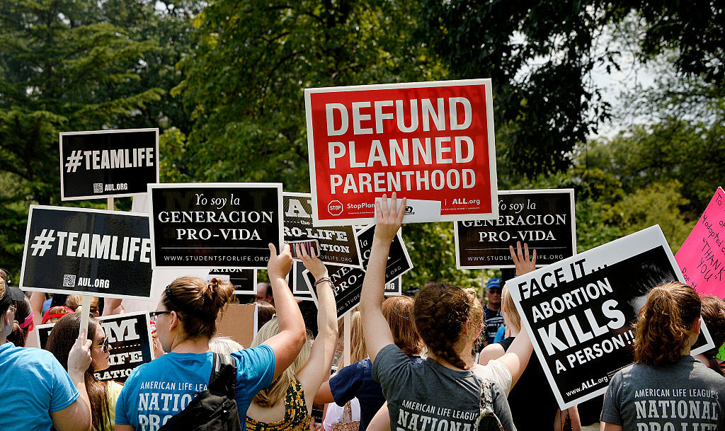Americans United for Life has written model legislation that called for "Defunding Abortion," targeting organizations including Planned Parenthood that also provides reproductive health care services including birth controls, STI testing and other screening. (Photo by Olivier Douliery/Getty Images)