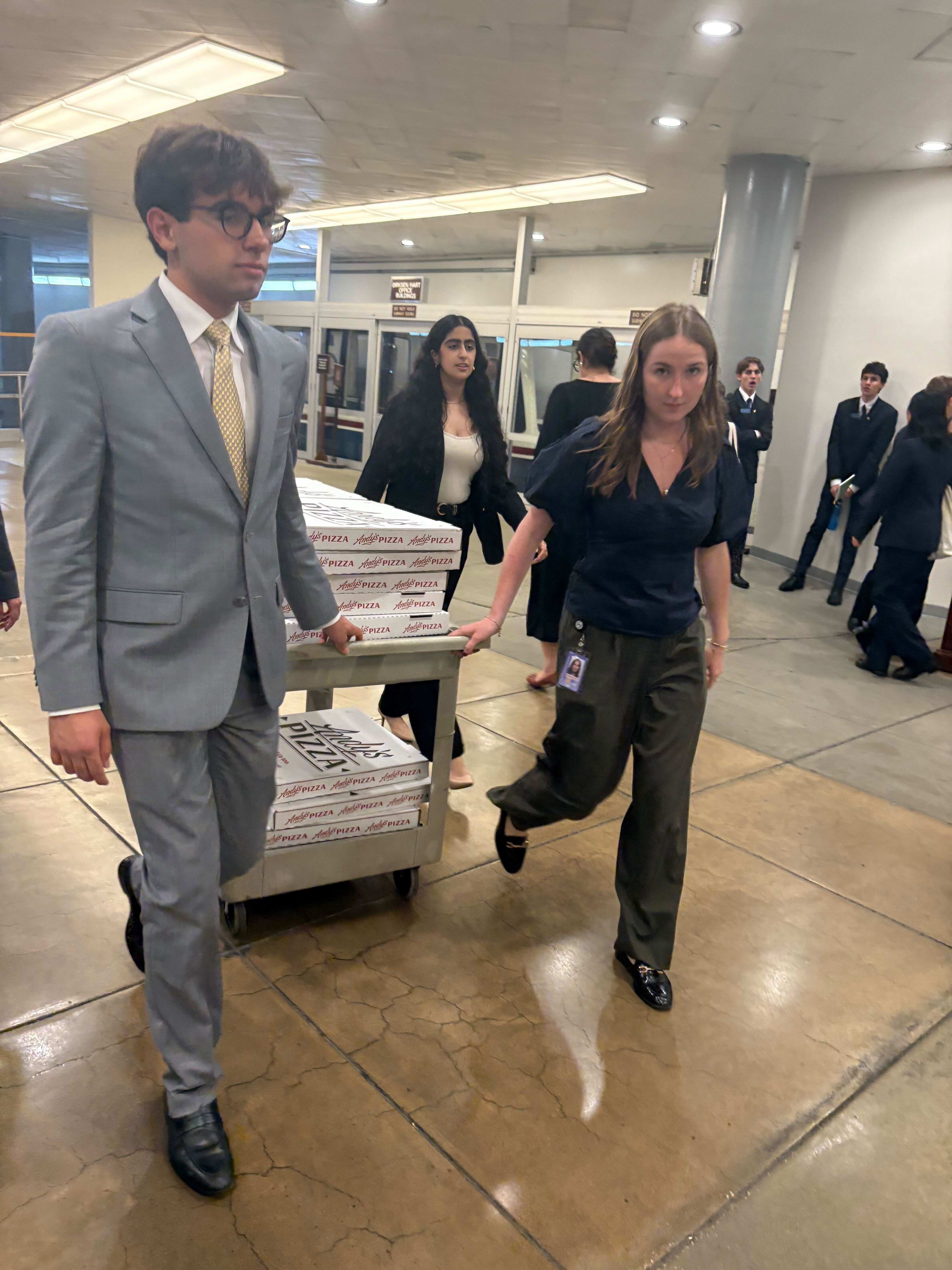 U.S Senate staffers wheel pizza into the Capitol around 6 p.m. during a marathon voting session on July 16, 2025. (Photo by Jacob Fischler/States Newsroom)