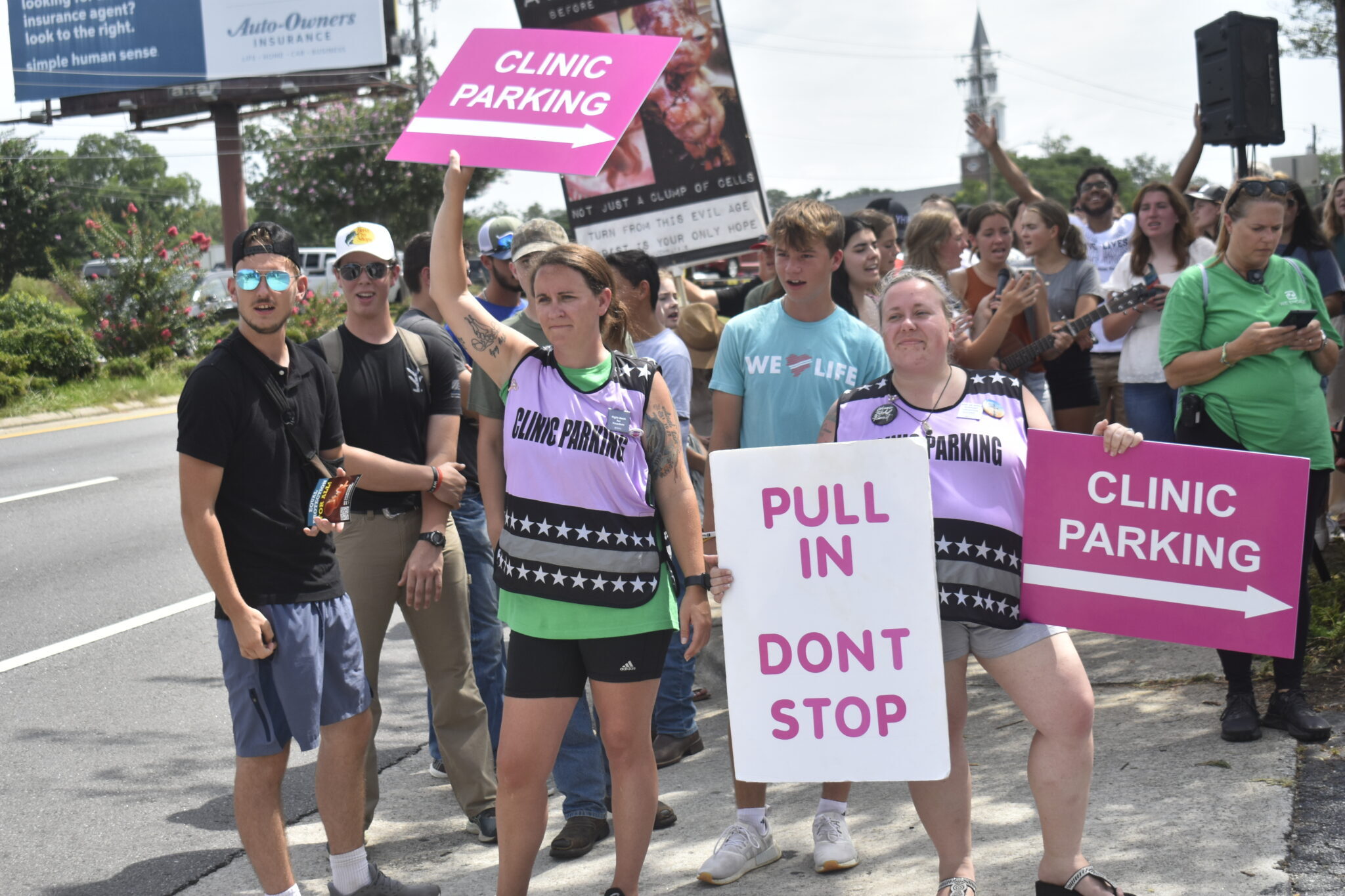 Clinic escorts attempt to stand between patients and anti-abortion protesters outside A Preferred Women’s Health Center of Atlanta in Forest Park, Georgia, in July 2023