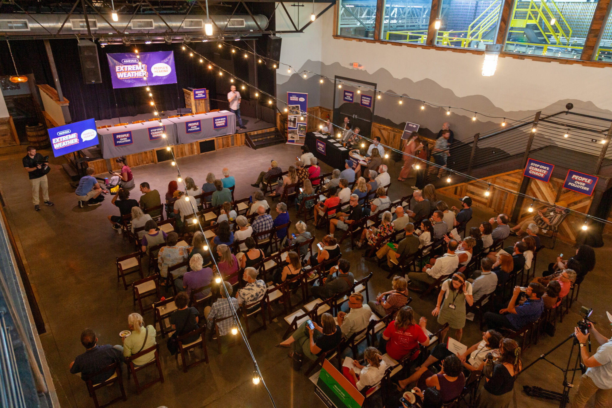 Chantal wreaks havoc in NC as state lawmakers try to repeal an ambitious climate change goal an overhead shot of dozens of Helene survivors at a public meeting