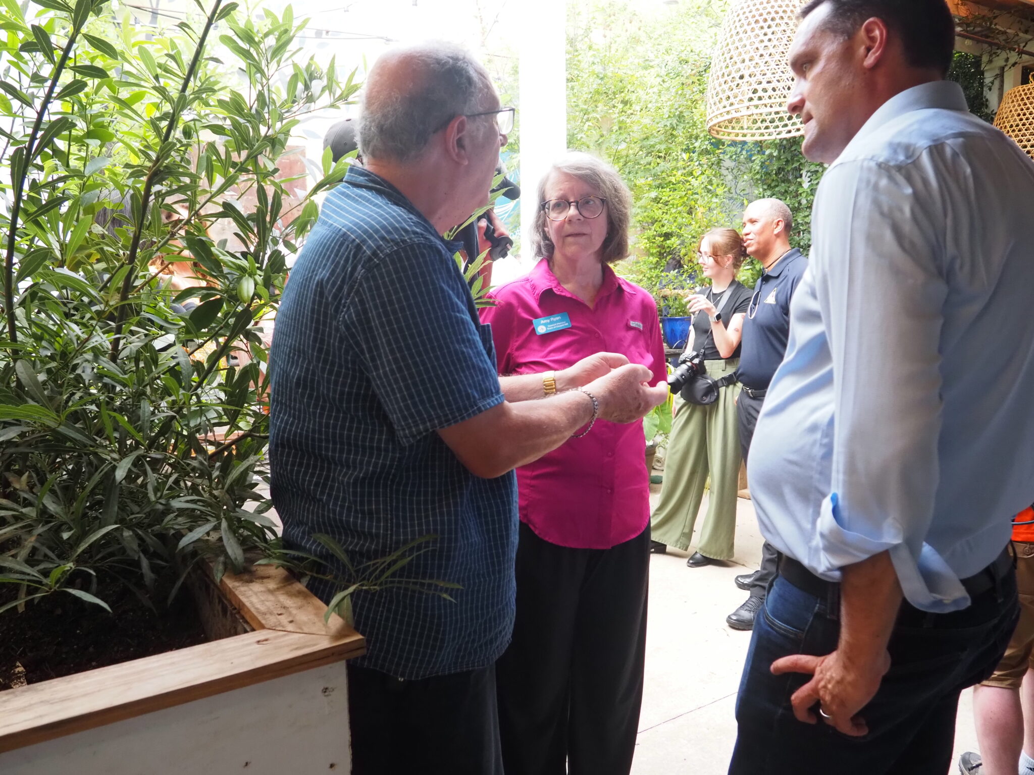 After Chantal flooding, Governor Stein surveys damage in Chapel Hill, urges federal relief A man speaks to two elected officials at the patio of a Greek restaurant.