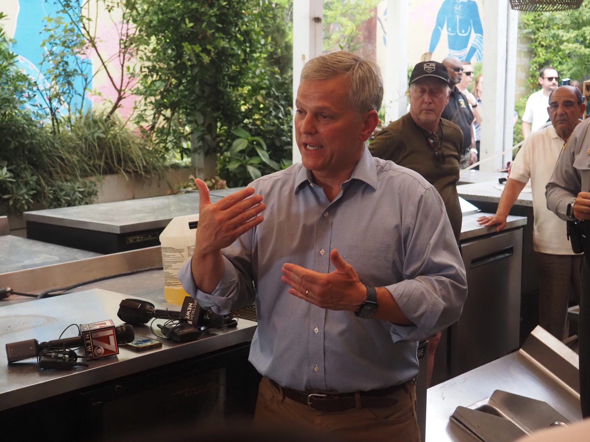 After Chantal flooding, Governor Stein surveys damage in Chapel Hill, urges federal relief Josh Stein gestures with his hands, standing beside a table with microphones.