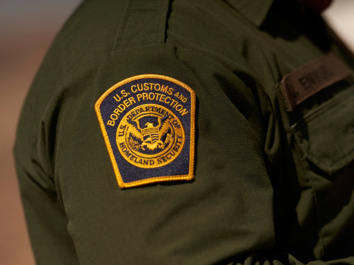 A surprising immigration raid in Kern County foreshadows what awaits farmworkers and businesses A close-up view of a U.S. Customs and Border Protection patch on the left arm of an agent's green uniform. The patch contains the words "U.S. Customs and Border Protection" and "U.S. Department of Homeland Security" and its logo, which includes an eagle's breast as a shield divided into three sections containing elements that represent homeland - air, land, and sea.