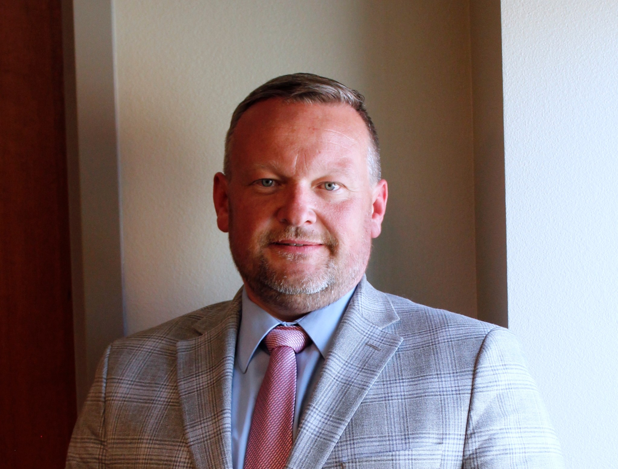 No lawyer? A new program in Casper could help you navigate the court system. Victor stands against a beige wall