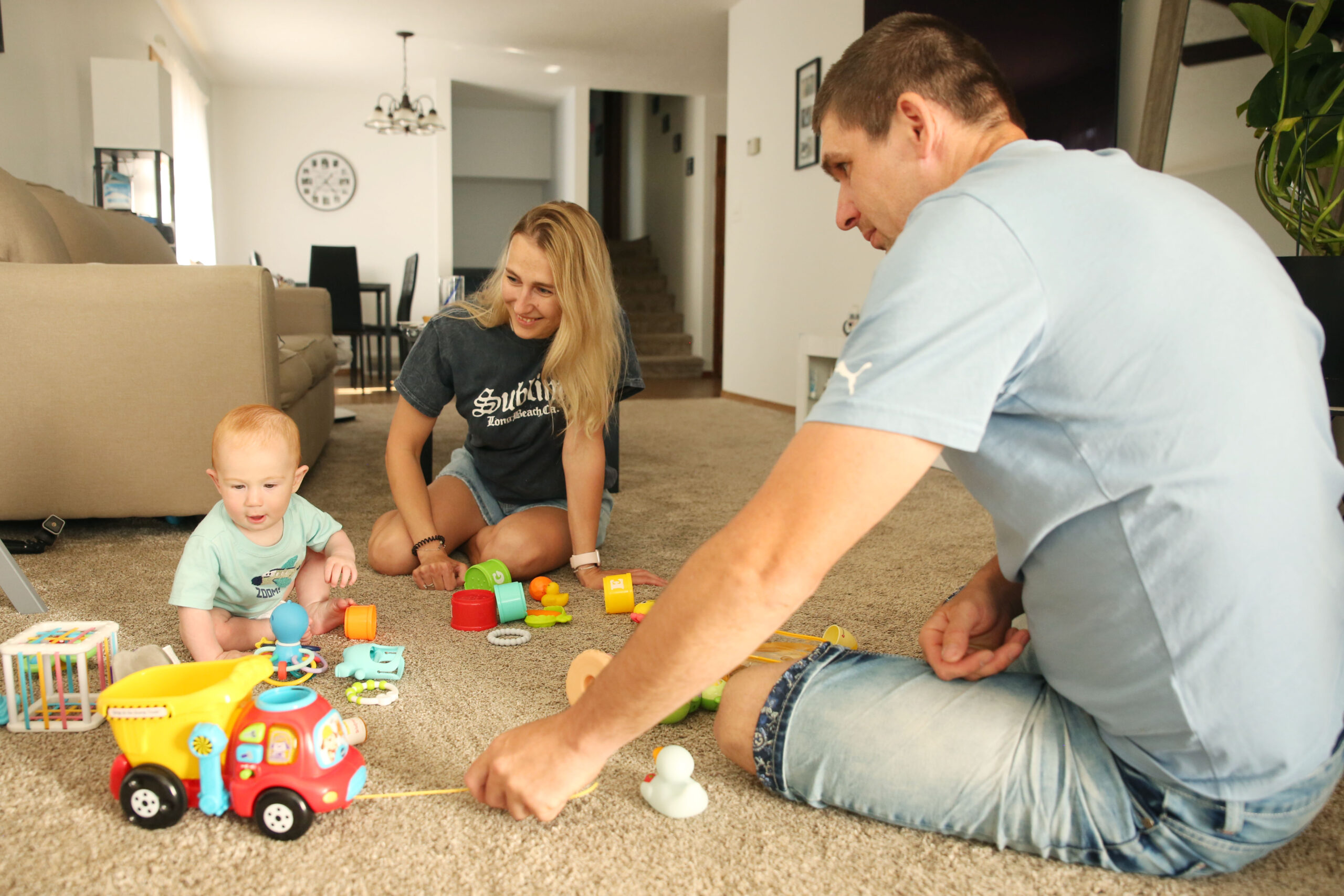 ‘This is our home’: Ukrainians settled in SD fear Trump-Noem policies will force them to leave Ilona and Valerii Biliaze play with their 7-month-old son Brian in their Watertown home on May 12, 2025. (Makenzie Huber/South Dakota Searchlight)