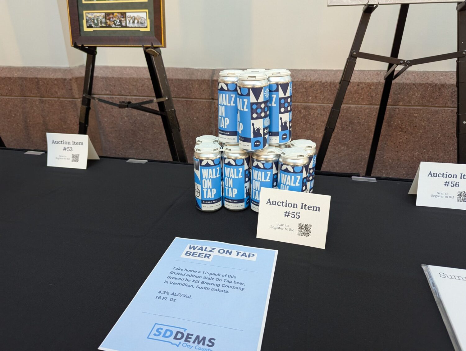 Former vice presidential candidate calls Noem ‘antithesis of the South Dakota I know’ Cans of "Walz on Tap" are on display for a silent auction at the 2025 McGovern Day dinner on July 13, 2025, in Sioux Falls. (John Hult/South Dakota Searchlight)