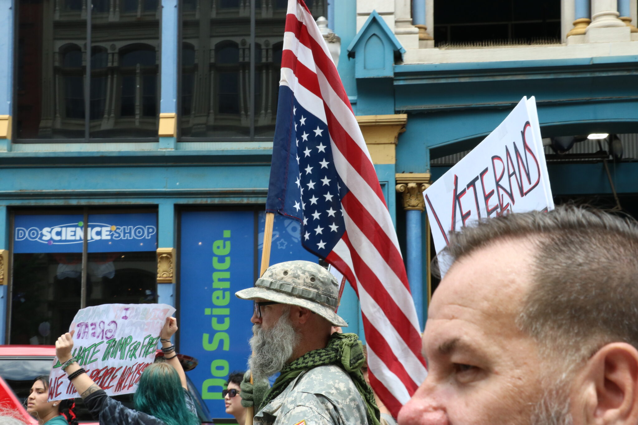 ‘No Kings,’ say Kentuckians turning out for nationwide day of protest Andrew Schmidt, center, holds an American flag flying upside down while wearing an Army field uniform.