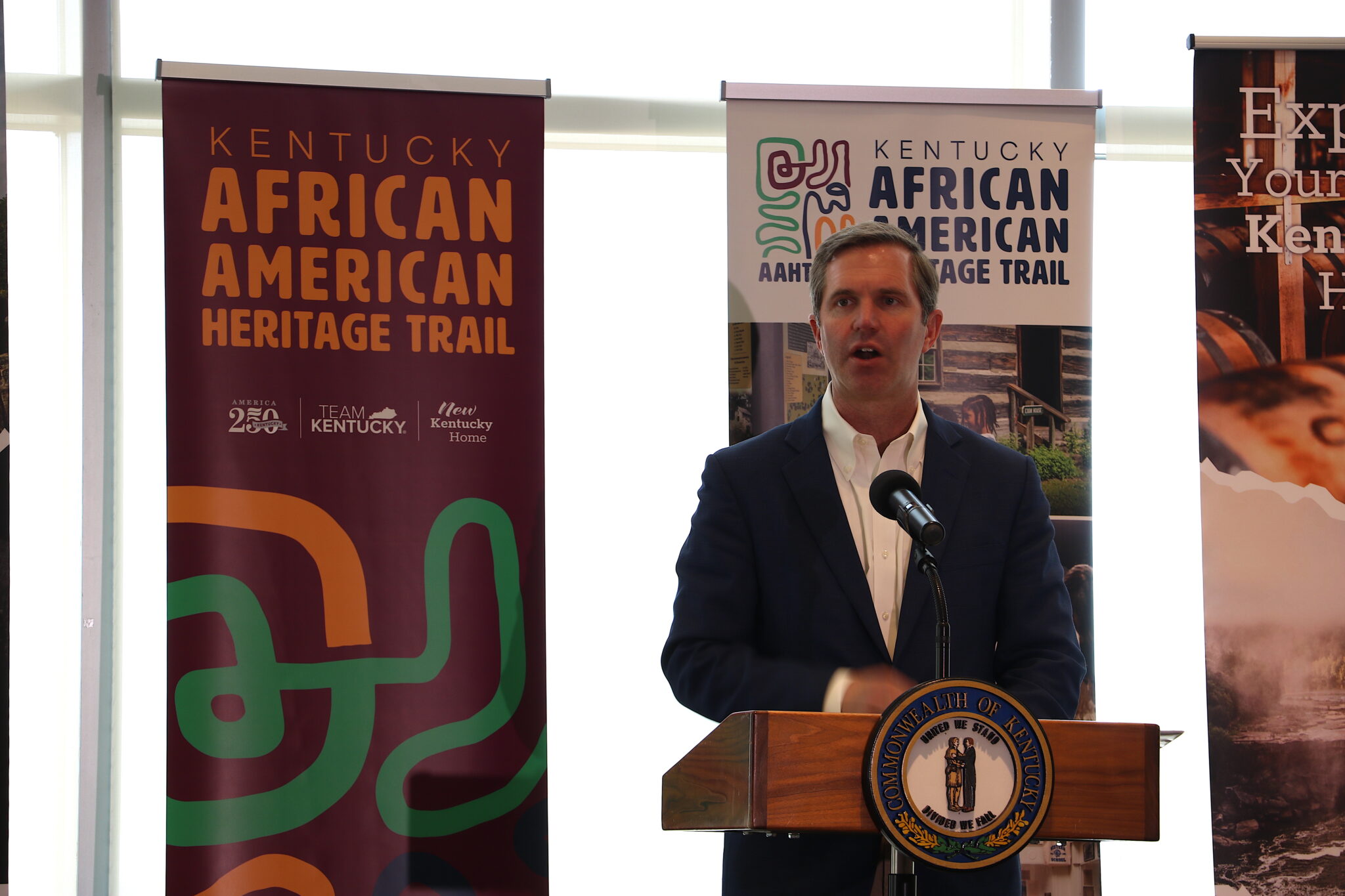 New Kentucky tourism trail showcases Black history and heritage Beshear stands in front of a podium.