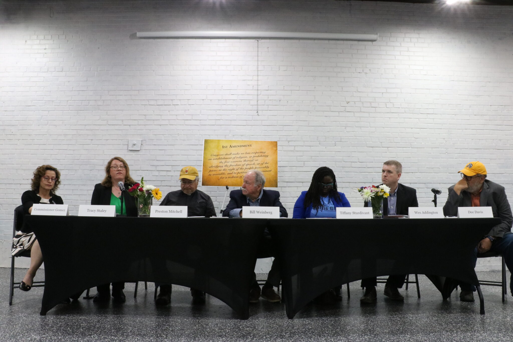 Push back against Trump to protect ‘precious liberties,’ lone Democratic regulator urges Kentuckians A row of people at a table.