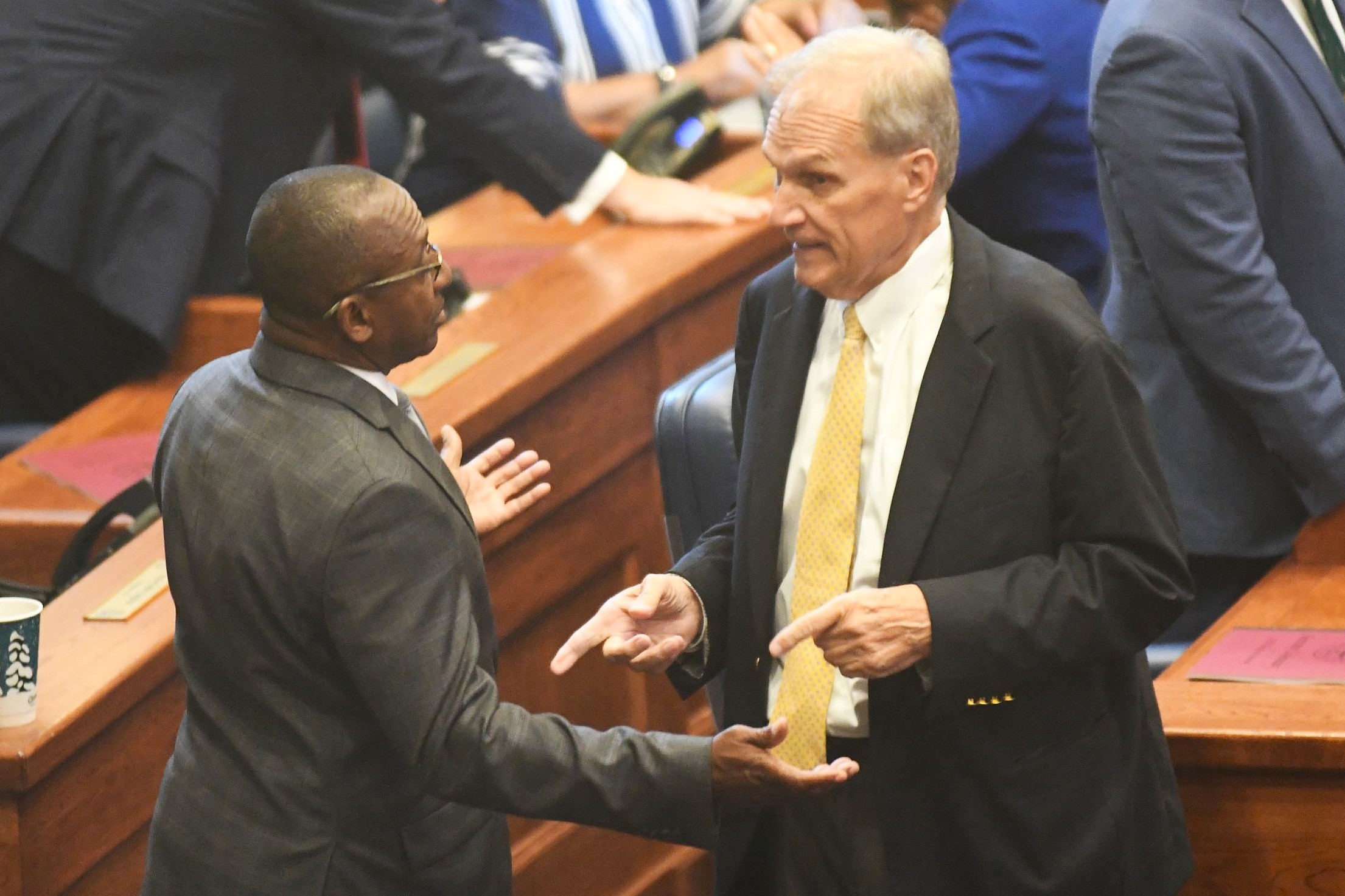 Alabama House and Senate clash over local legislation as session nears end A man in a grey suit with his arms wide speaking with a man pointing his fingers at him