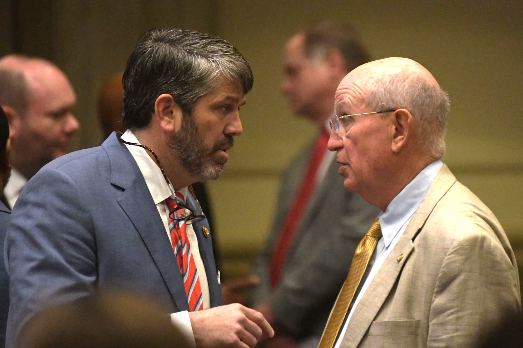 Alabama House and Senate clash over local legislation as session nears end A man in a beige jacket and yellow tie speaking to a man in a light blue jacket and red tie with white stripes.