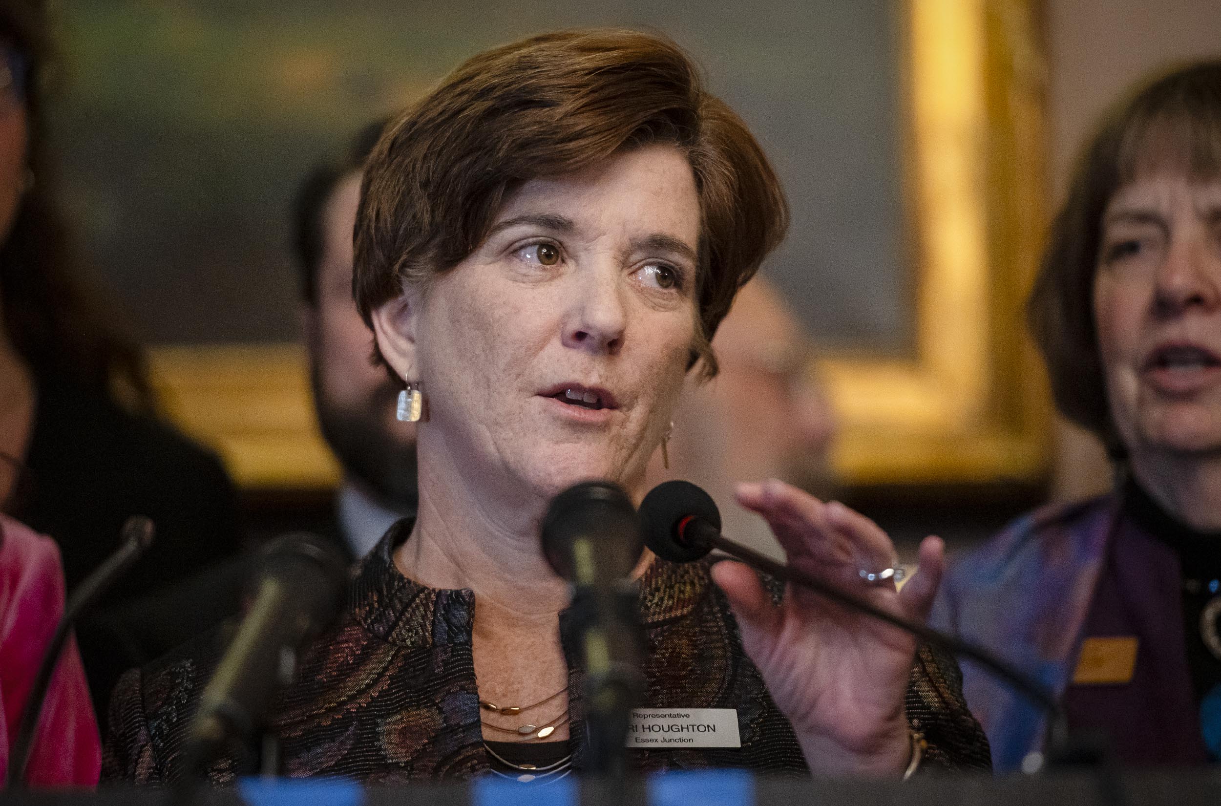 Anti-abortion advocates drop federal lawsuit against Vermont after lawmakers nix language targeting crisis pregnancy centers A woman speaking at a podium with microphones in front of her, with several people in the background.
