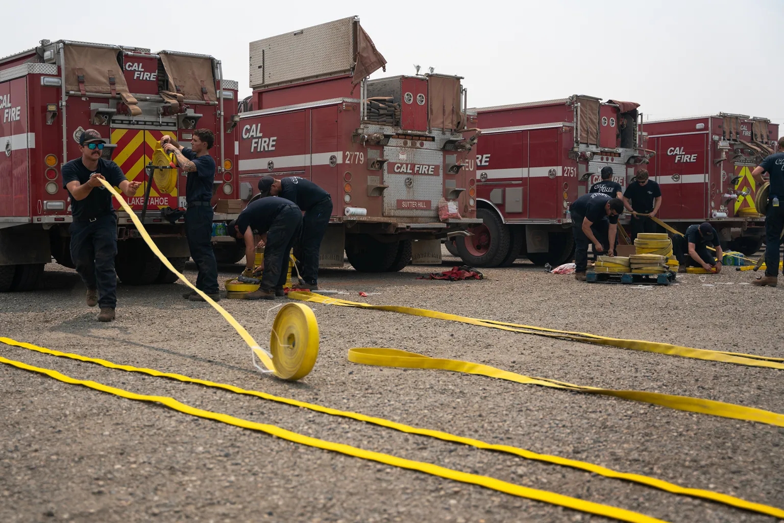 California battles onslaught of wildfires with help from mutual aid Cal Fire crews are rewinding hoses at the Park Fire command post in Chico on Aug. 2, 2024. (Photo by Florence Middleton/CalMatters)