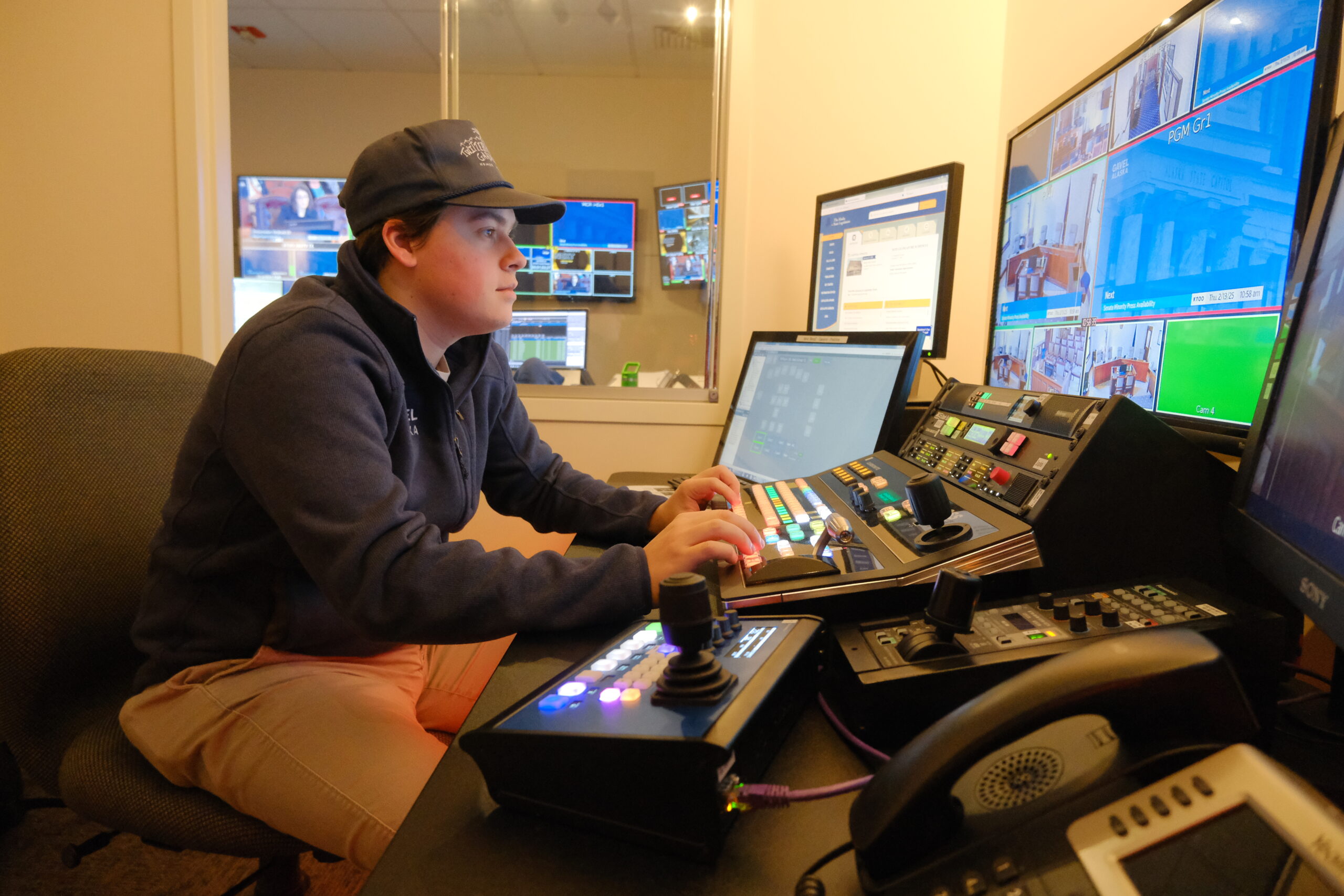 Behind the cameras: Gavel Alaska broadcasts the business of state government to Alaskans Tulio Fontanella, a first-year production technician with Gavel covers a Senate Finance Committee meeting on Feb 13, 2025 (Photo by Corinne Smith/Alaska Beacon)