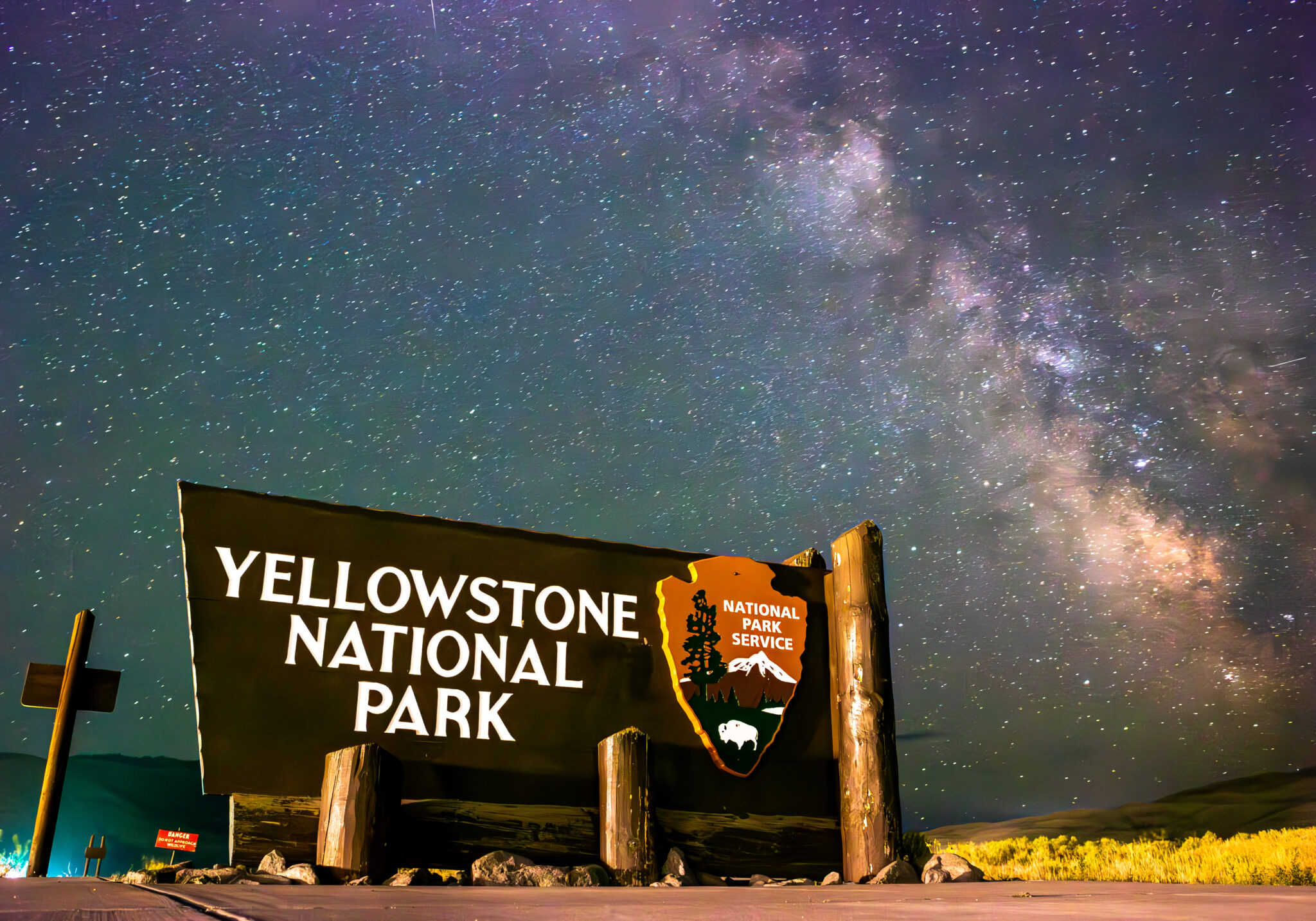 Road trips, bear spray and a full moon(ing): How we made the Howl podcast and story series Stars shine brightly behind the welcome sign at the North Gate on July 10, 2024, at Yellowstone National Park