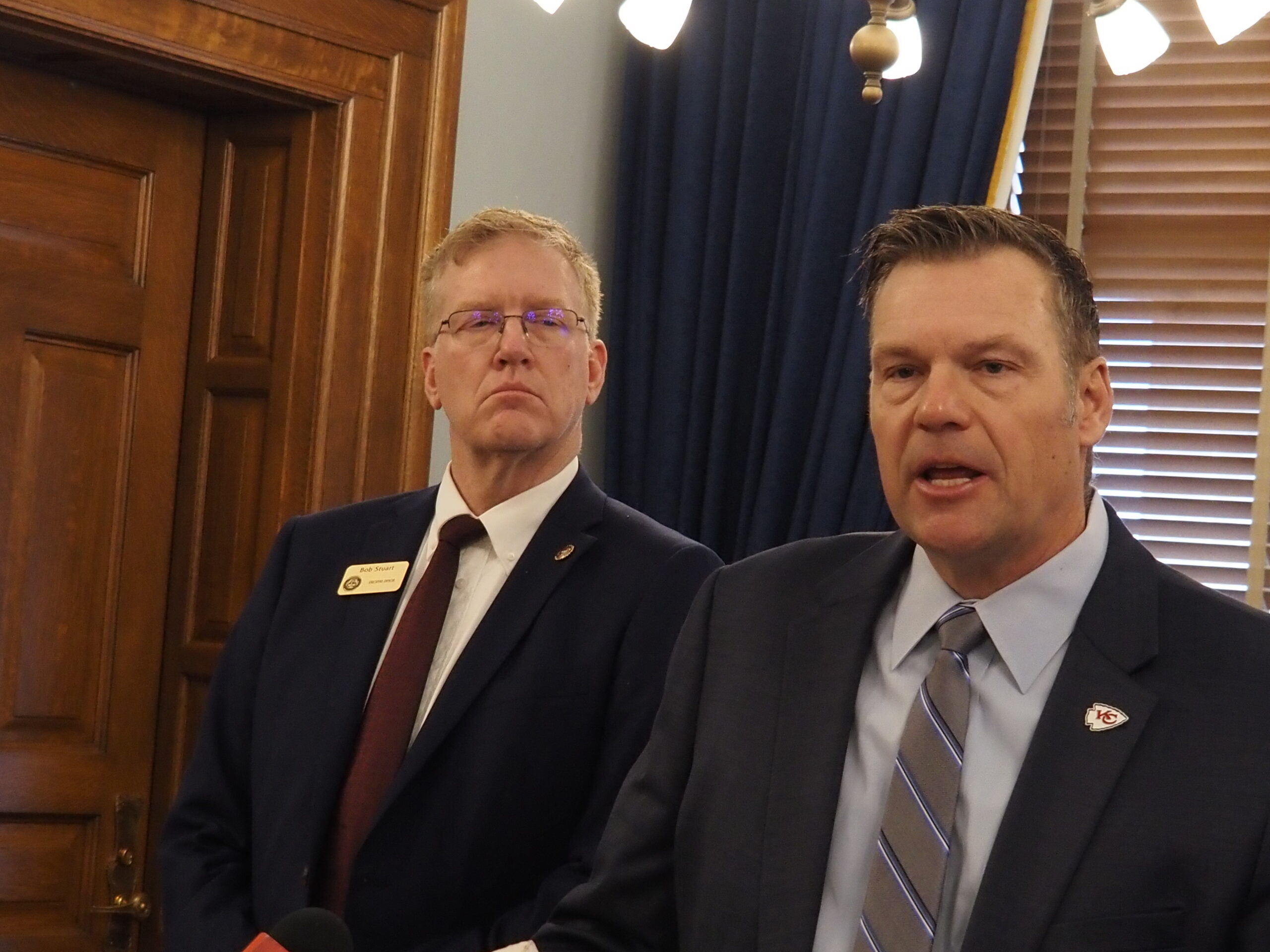 In Kansas, a trifecta of xenophobia does nothing to help the humanitarian crisis 700 miles away Kansas Attorney General Kris Kobach announced a new attempt to ban foreign ownership of Kansas farmland during a Feb. 6, 2024 news conference. (Rachel Mipro/Kansas Reflector)