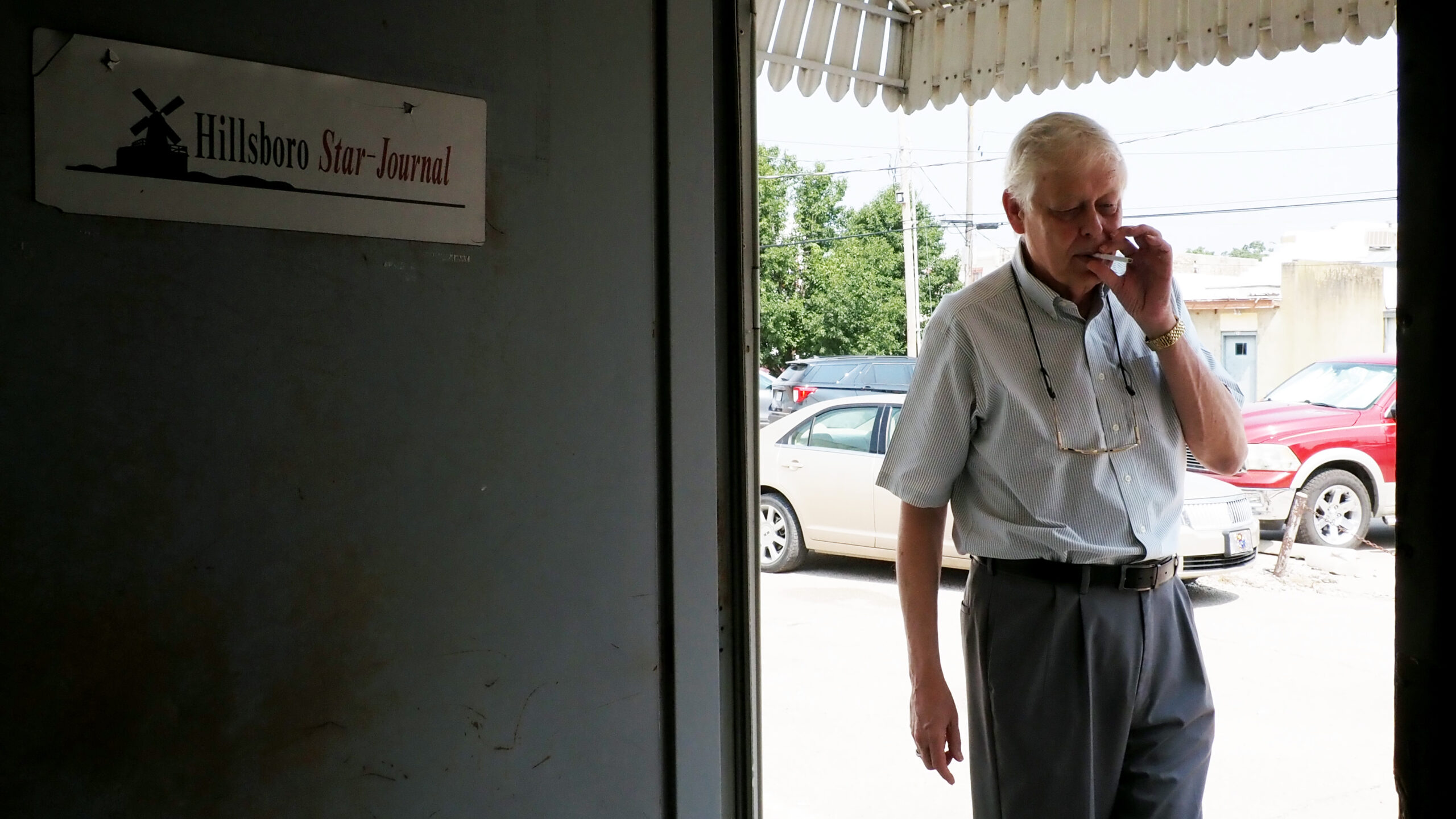 News of police raiding a Kansas newspaper unfolded like ‘a novella.’ The story keeps churning. Marion County Record editor Eric Meyer smokes in the back door of the newspaper office on July 25, 2024