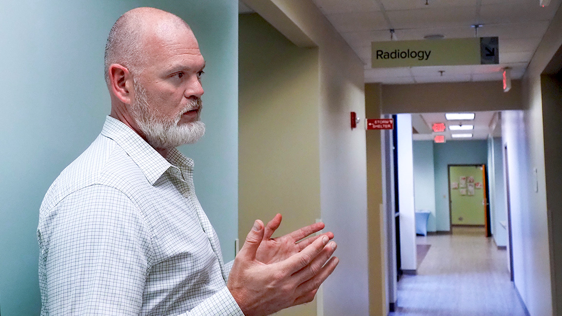 In southeast Kansas, housing is treated as health care, and people are getting off the streets Jason Wesco, president of the Community Health Center of Southeast Kansas, walks around the center’s clinic in north Pittsburg, where patients can receive care regardless of their ability to pay. (Anna Kaminski/Kansas Reflector)