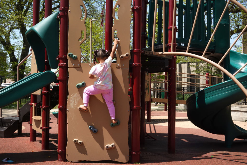 Trump says ‘Child care is child care.’ Voters want more than that. A 5-year-old girl plays on a climbing wall at a playground in Illinois