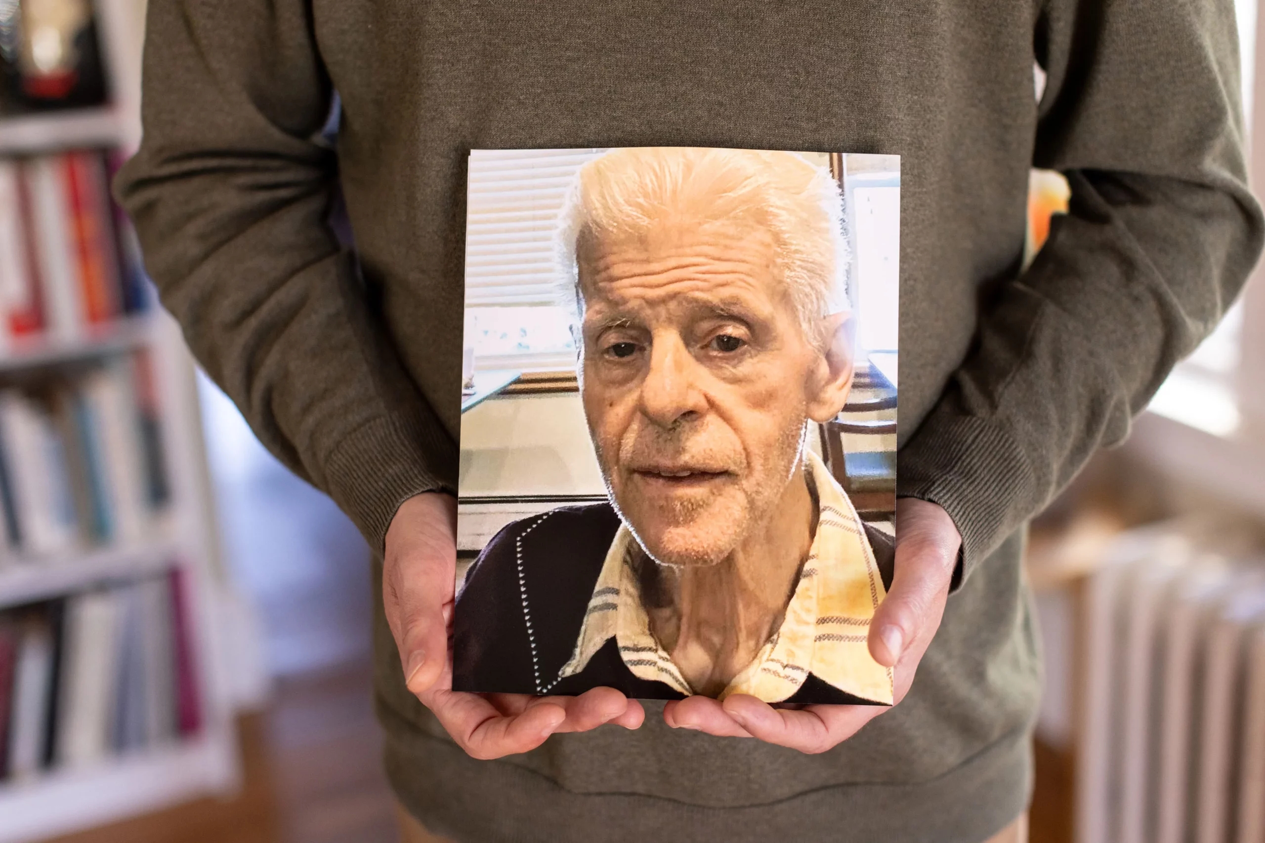 Residents suffer when nursing homes ignore or waive staffing rules Jason Travers holds a photo of his father George.