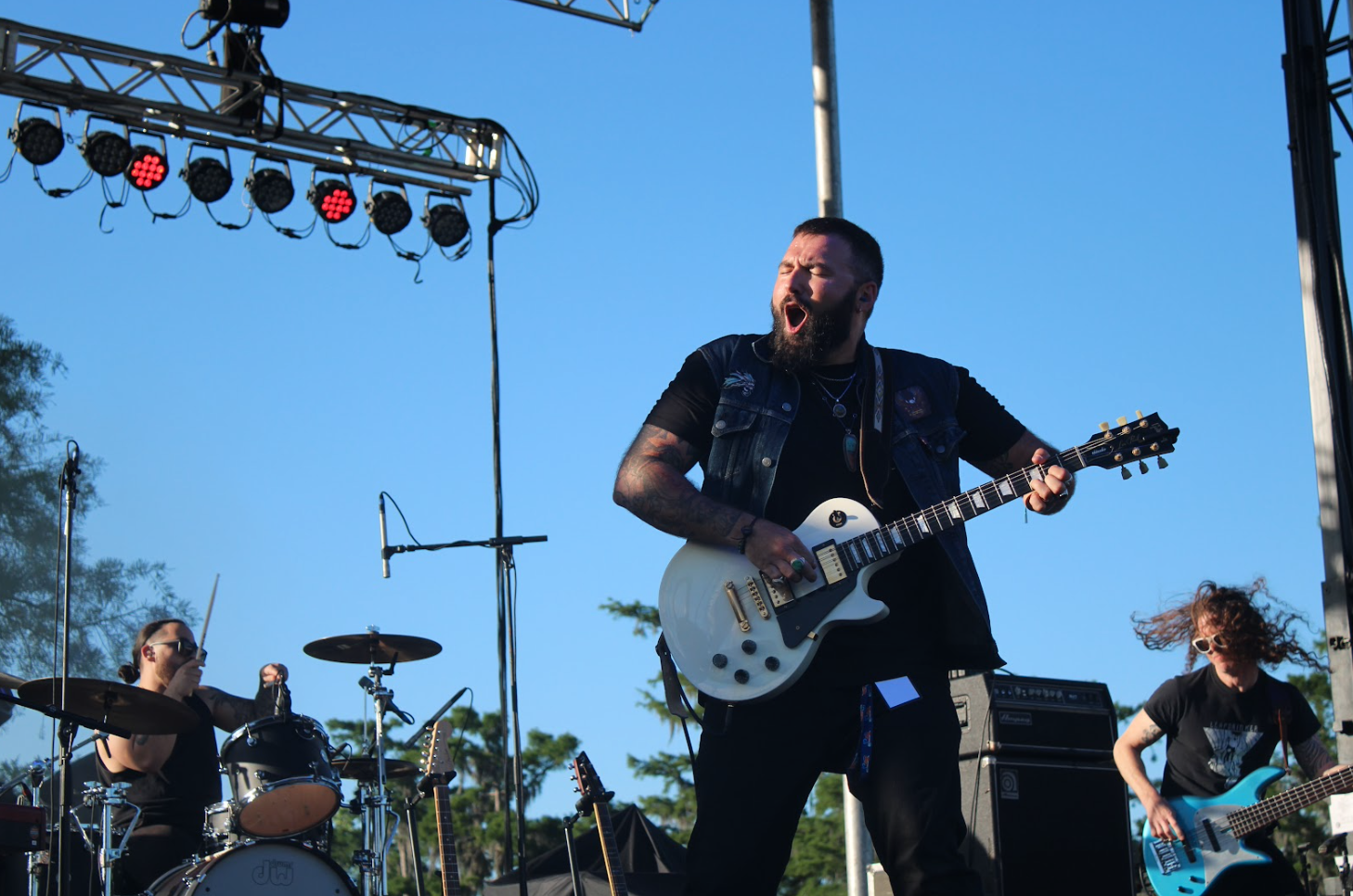 Jean Lafitte residents adapt to life on the edge of survival Theophile Bourgeois IV plays his guitar on stage at the town seafood festival in April 2024. (Aidan McCahill for Louisiana Illuminator)