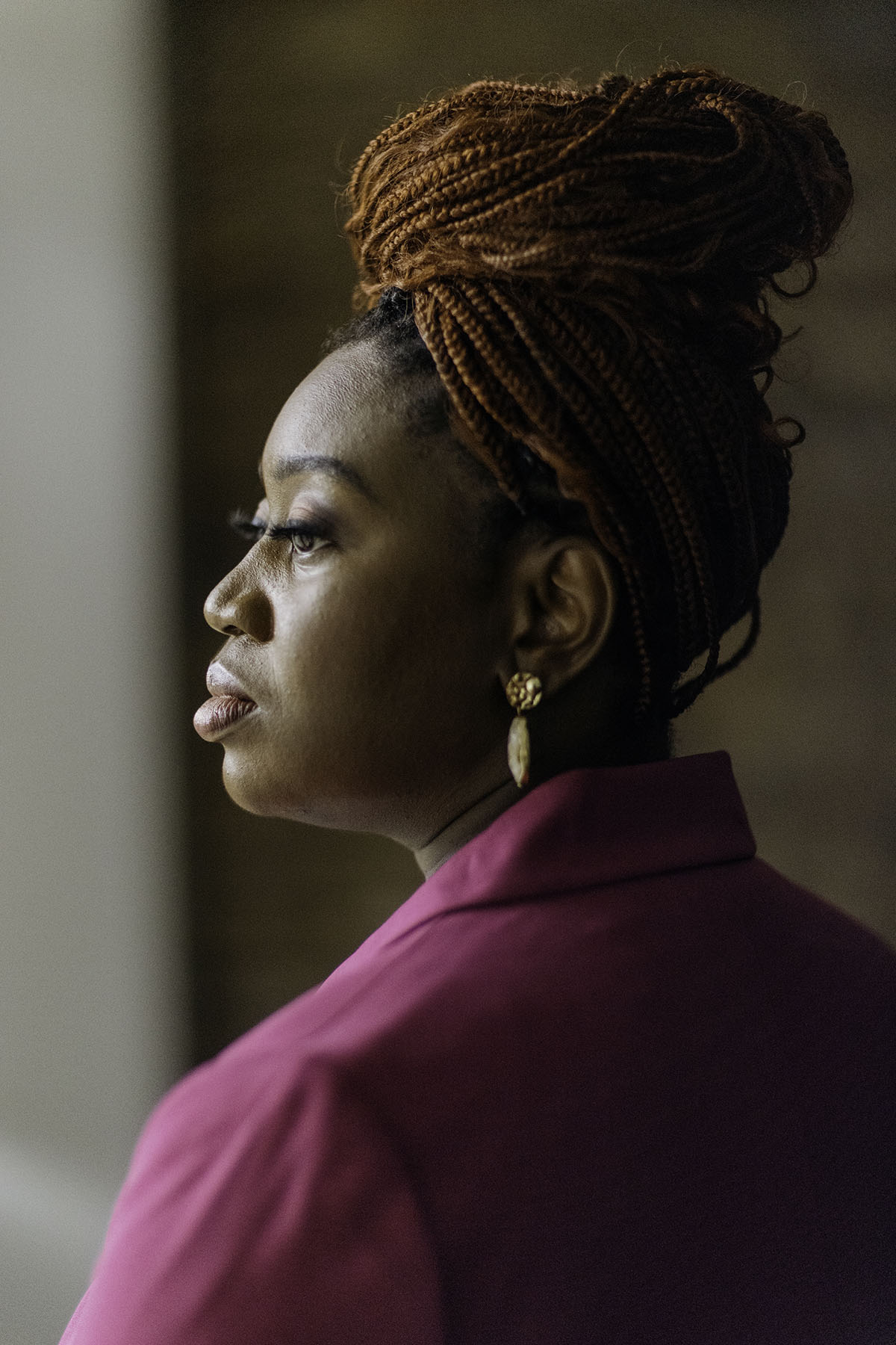 ‘Voting feels like a battle’: A group of Black women reimagines voter turnout Profile shot of Velvet Scott in a pink suit, looking contemplative. Her braided hair is styled up, and she is wearing gold earrings.