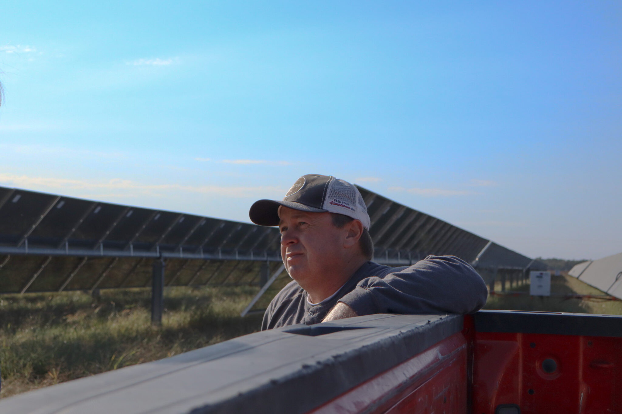 As solar energy expands in the Delta, agrivoltaic projects hope to shine Chad Raines leans on the bed of his pickup truck with solar energy panels in the background at his farm near Searcy, Arkansas.