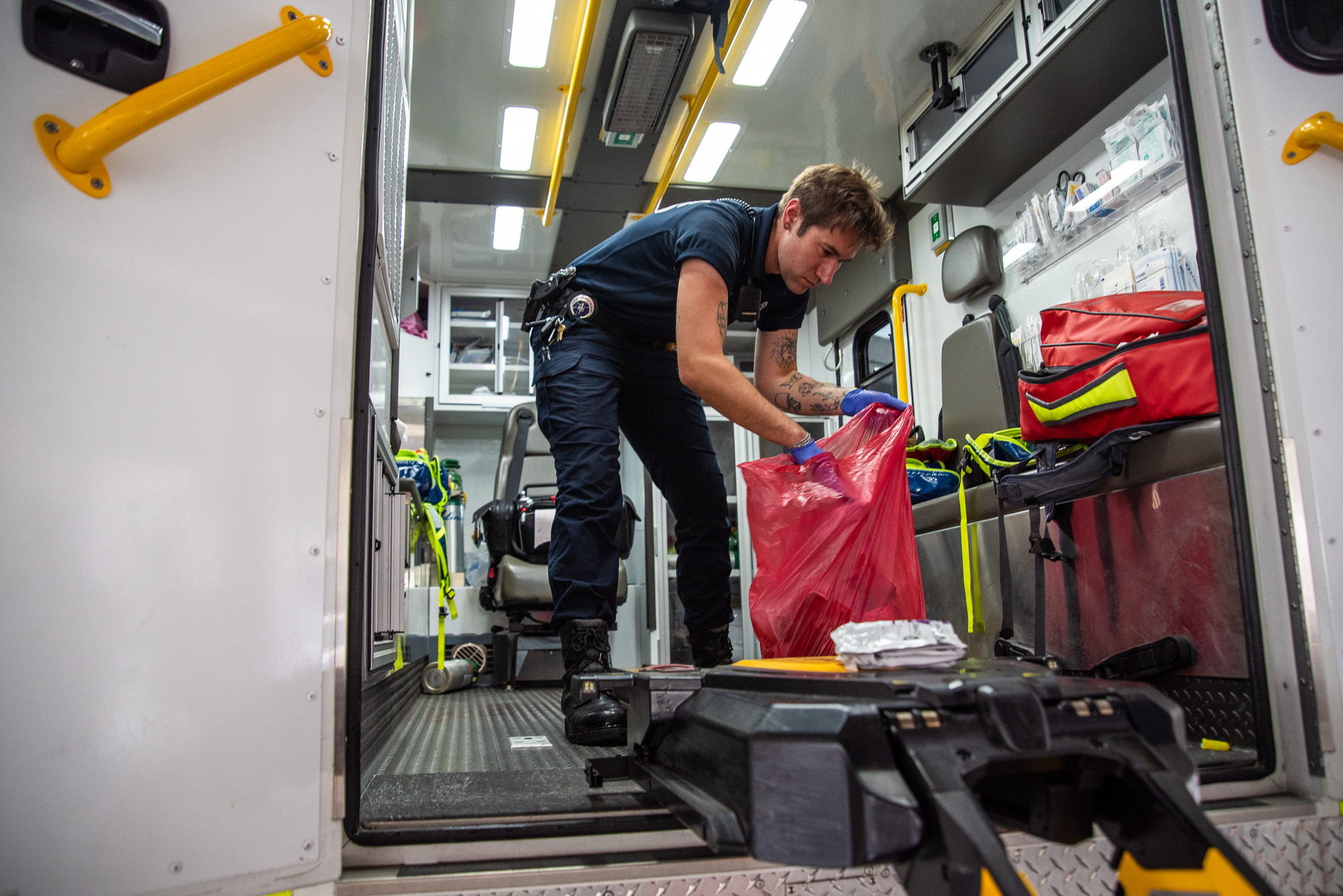 Despite pay problems and staff turnover, New Orleans EMS takes each call in stride New Orleans EMT Daniel Rokos throws away trash and cleans an ambulance while parked at University Medical Hospital