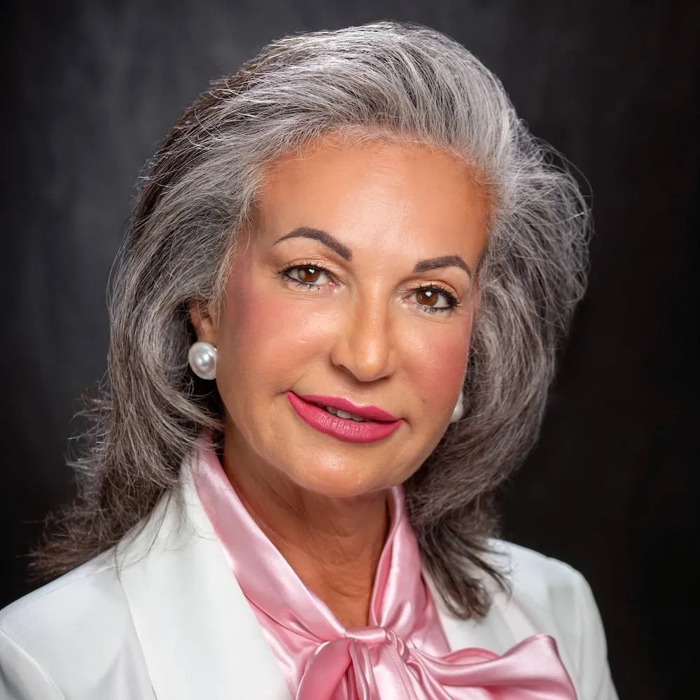 LSU board member accused of harassment, retaliation A headshot of a woman with gray hair wearing a white blazer and a pink blouse