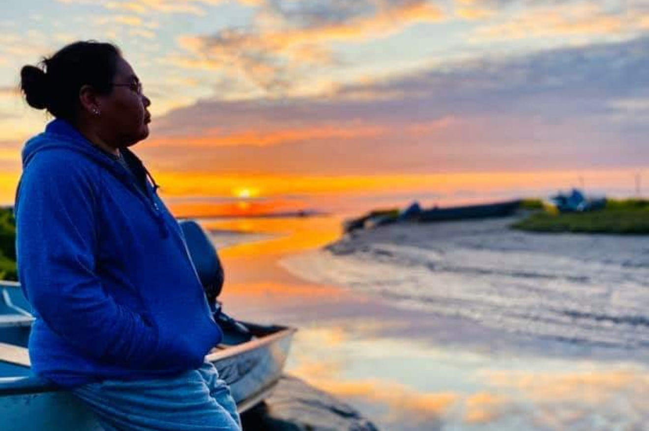 Floods are swallowing their village. The EPA has cut their lifeline. Rayna Paul, environmental director for the Native Village of Kipnuk, is pictured looking out over the waterfront of her village.
