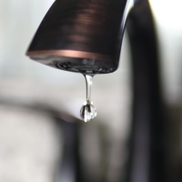 Close-up photo of water dripping out of a faucet