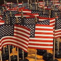 American flags sit on a table a wooden table before a naturalization ceremony at the federal courthouse in downtown Indianapolis