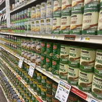 Cans of vegetables sit on shelves in grocery store
