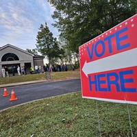 Georgia voters stand outside in line at their polling place in 2024