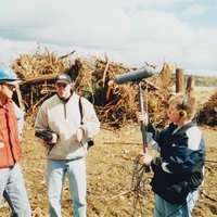 Tim Lambert stands in a field the Somerset County Coroner  on the right records the conversation at the Flight 93 crash site on Oct. 6, 2001.
