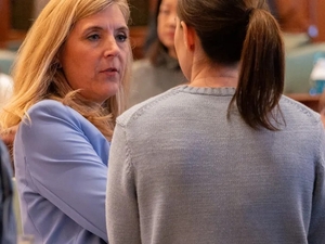 Rep. Terra Costa Howard, D- Glen Ellyn, speaks to a House colleague shortly after making a speech on April 11, 2025, in favor of her bill creating new homeschool oversight in Illinois. (Capitol News Illinois photo by Andrew Adams)
