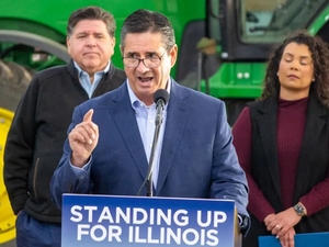 Jerry Costello II, director of the Illinois Department of Agriculture, speaks at a Christian County farm alongside Gov. JB Pritzker (left) and Cameron Joost, assistant director of the Illinois Department of Commerce and Economic Opportunity. The group discussed the impact of tariffs on Illinois farmers in an October visit. (Capitol News Illinois photo by Jerry Nowicki)