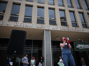 Student protesters shout during a “Hands Off Our Schools” rally in front of the U.S. Department of Education building in Washington, D.C., in April. The same group held a virtual press conference Tuesday to protest President Donald Trump’s efforts to dismantle the U.S. Department of Education. (Photo by Kayla Bartkowski/Getty Images)