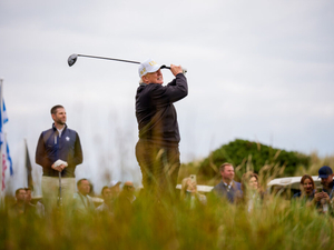 U.S. President Donald Trump, accompanied by his son Eric (L), tees off at a new 18-hole course at Trump International Golf Links on July 29, 2025 in Balmedie, near Aberdeen, Scotland. (Photo by Andrew Harnik/Getty Images)