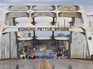 A crowd gathering at the foot of the Edmund Pettus Bridge in Selma, Alabama, on March 9, 2025. The U.S. Supreme Court Wednesday gutted a key portion of the Voting Rights Act, passed after law enforcement attacked civil rights marchers on the bridge on March 7, 1965, an event known as Bloody Sunday. (Anna Barrett/Alabama Reflector)