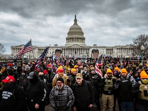 A mob of Trump supporters gathers in front of the U.S. Capitol Building on Jan. 6, 2021 in Washington, DC. An "anti-weaponization" fund was created by the Department of Justice in May 2026 that could make payments to those who took part in the Jan. 6 attack. (Photo by Jon Cherry/Getty Images